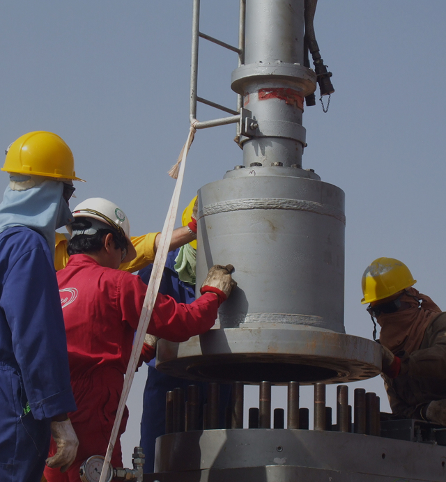 Welder performing in-service welding on industrial pipeline